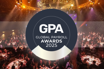Guests dining at the 2025 Global Payroll Awards, with stage lights and GPA logo displayed prominently